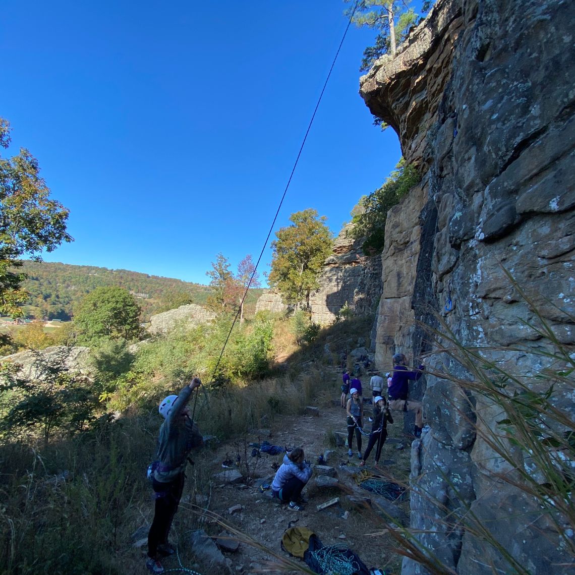 People climbing a wall of rock 